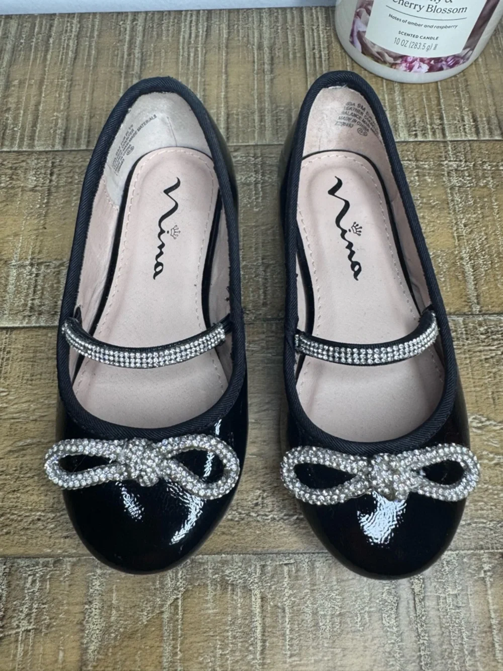 Nina Kendalla Ballet Flat in Black Crinkle Patent with Rhinestone Bow
